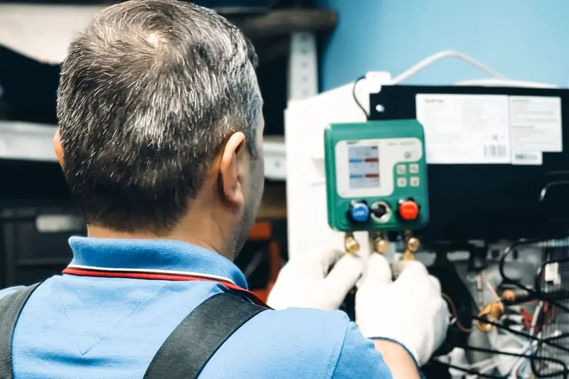 Technician checking an air conditioning system with gauges, the kind of service that finds condensate leaks in Cary, NC homes