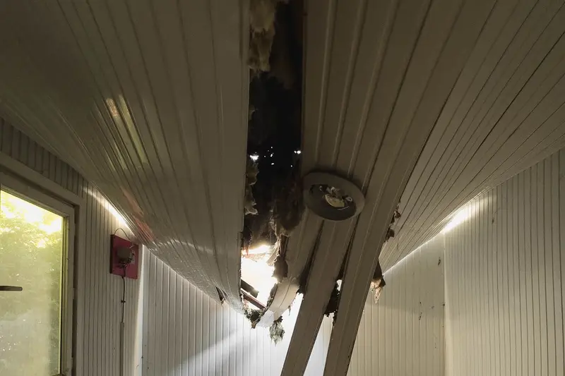Ceiling boards collapsed and hanging after water came through from above, the kind of ceiling damage seen in Cary, NC homes
