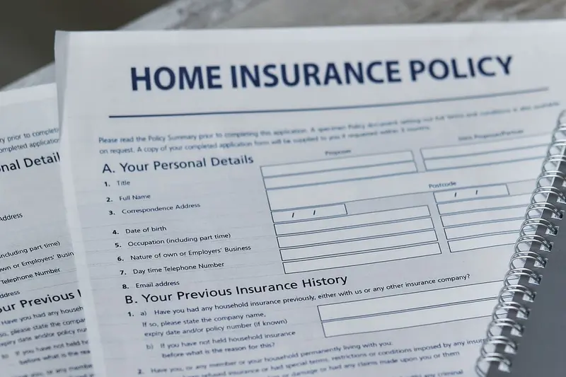 Home insurance policy form on a desk with a pen, the paperwork behind a water damage claim in Cary, NC