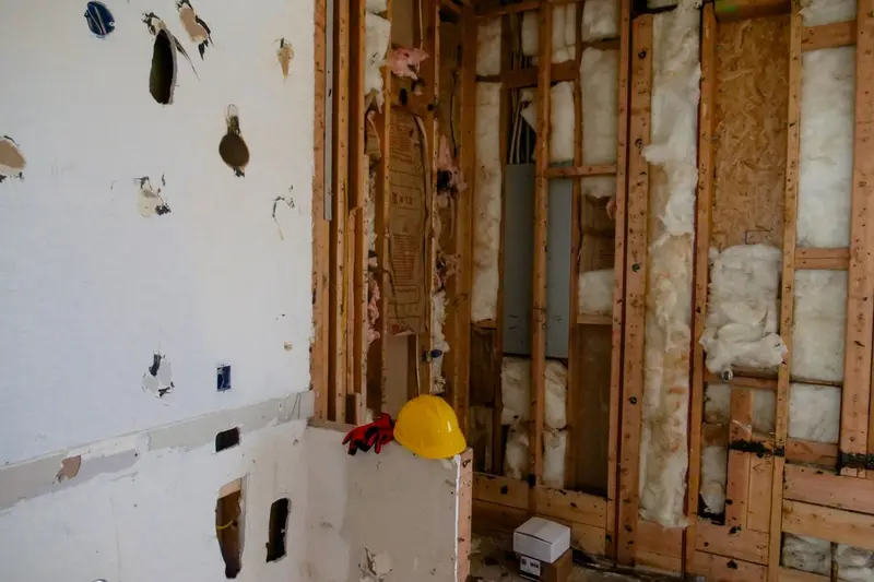 Wall opened to the studs with drywall and insulation cut out during water damage restoration in Cary, NC